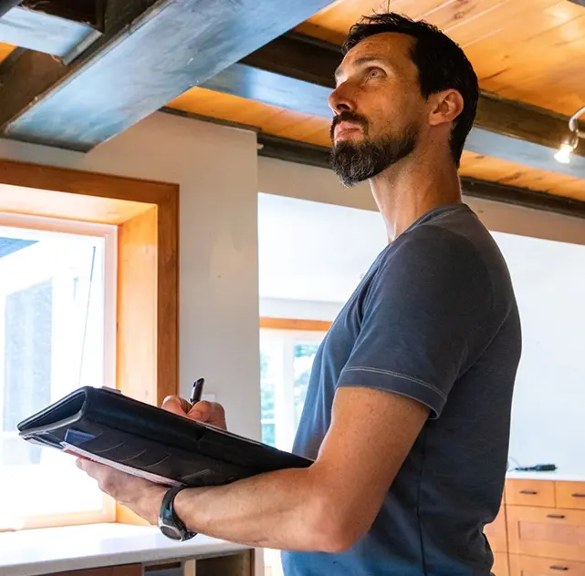 NSPIRE inspector documenting deficiencies at a HUD property